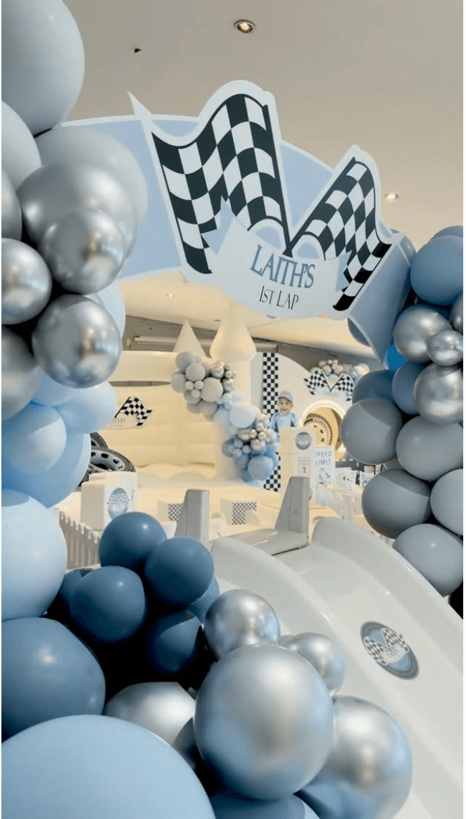 Racing themed celebration with blue and cream balloons