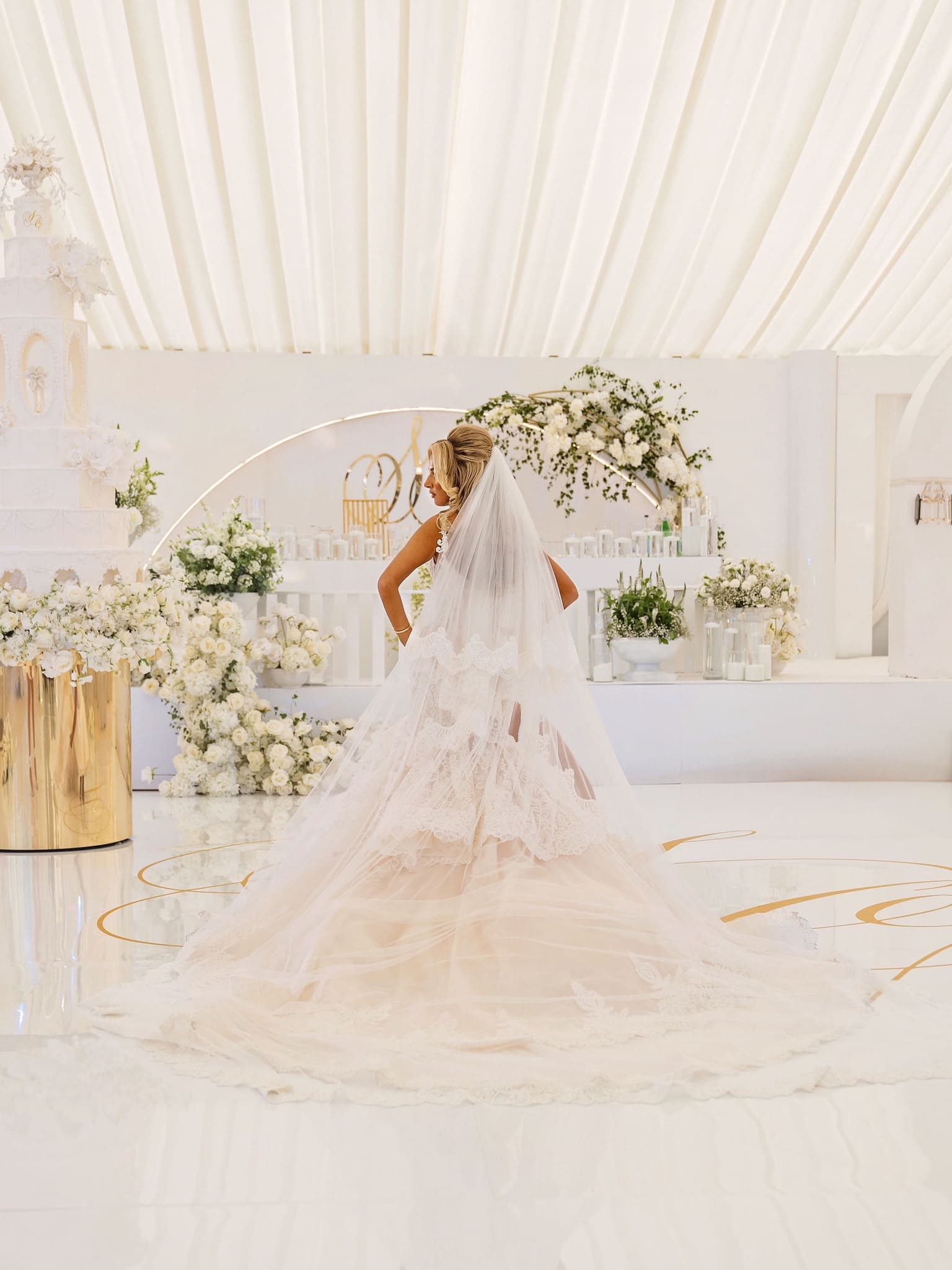 Bride in a white and gold floral wedding setting